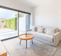 Recreational apartment with a comfortable sofa, table, and large window.
