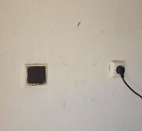 A wall with an electrical outlet in the garages on Jesenského Street in Zvolen.