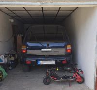 A garage with a car and an electric scooter, stored items, and a drawing on the door.