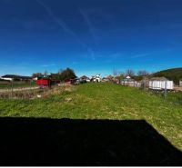 Lands - housing in Pernek, open green area, with fencing and a rural scene in the background.