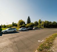 Road with parked cars and a billboard on Partizánska Street, Banská Bystrica, Land - housing.