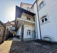 Mansion of peculiar real estate in Banská Bystrica with stone details and curb paving.