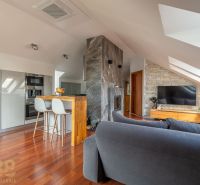 Interior of a 3-room apartment with a fireplace and flooring with a wooden decor.