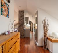 Interior of a 3-room apartment with a wooden decor floor and a wooden sideboard.