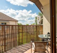 Balcony of a 3-room apartment with a view of greenery and a neighboring house in Poprad.