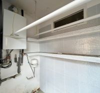Boiler room in a family house, with a gas boiler and piping.