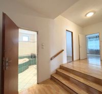 A staircase with a wooden floor leading to the bathroom in a family house.