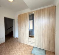 A cabinet with wood decor and tiles in a family house.
