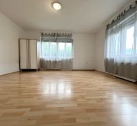 Interior of a family house with a wooden decor floor and two windows.