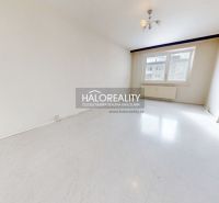 A spacious room with a white floor in a 3-room apartment, bright walls and a window.