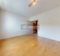 A room in a 3-room apartment with a wooden decor floor and white walls.
