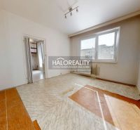 A room in a 3-room apartment with a window, wooden decor flooring, empty room.