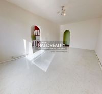 A spacious room in a 3-room apartment with a white floor and arched doorways.