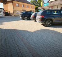 Parking lot at commercial premises in Turzovka with cars on the pavement.