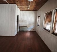 Commercial premises with a wood-patterned floor and walls with slat paneling.