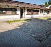 Commercial premises in Turzovka with a simple facade and paved access.