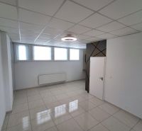 Offices with light tiles, white walls and windows, simple ceiling design.