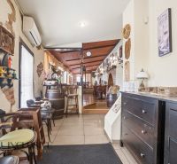 Interior of gastro spaces with decorations, a brick wall, and cozy wooden furniture.