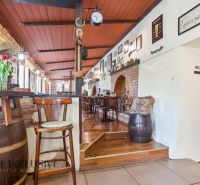 Interior of dining spaces with flowers on the table and decorative wooden elements.