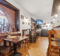 Wooden floor decor, brick walls, and comfortable seating in dining spaces.