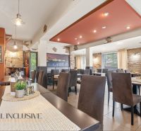 A restaurant with brick walls, a wooden decor floor, and cozy seating.