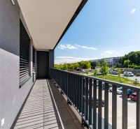 A balcony from a 3-room apartment in Košice - Západ with a view of greenery and a parking lot.