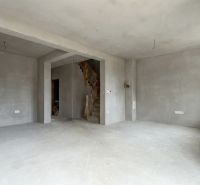 A raw interior in a family house with a staircase and preparation for electrical installation.