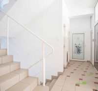 Staircase and hallway with white walls in offices.