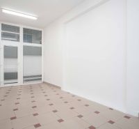 Offices with white walls, tiles, and glass doors create a clean space.