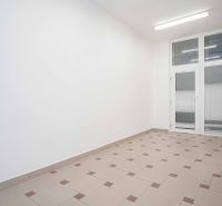 Interior of an office with white walls and tiles, ideal for work.