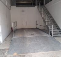 Interior of warehouses with a ramp and metal staircase; Warehouses and halls.