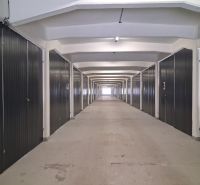A long corridor with garage boxes in warehouses and halls.