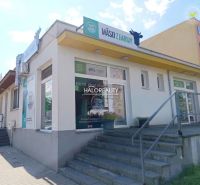 Commercial premises in Žiar nad Hronom with advertisements for farm meat and an entrance staircase.