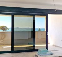 3-bedroom apartment with a terrace and sea view, wooden decor flooring.