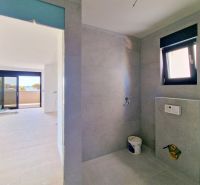 Bathroom with modern tiles in a 3-room apartment, view of the terrace.