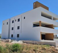 White apartment building with balconies in Privlaka against the blue sky, 3-room apartment.