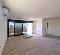 Spacious living area with wood-patterned flooring in a 3-room apartment.