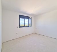 An empty room with an open window in a three-room apartment.