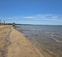 A beach with golden sand and calm sea in the town of Privlaka.