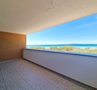 A balcony with a view of the beach and sea in a 3-room apartment in Privlaka.