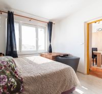 A bright room in a 3-room apartment with a bed and a spacious window.