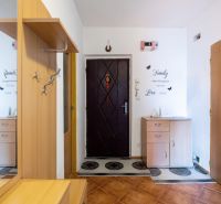 Entrance hall in a 3-room apartment with wooden decor and furniture.