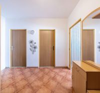 Entrance hallway in a 3-room apartment with practical furniture and wall decoration.