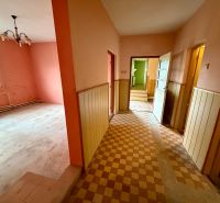 A hallway in a family house with colorful walls and tiles.