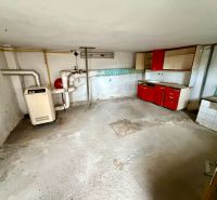 The basement of a family house with a boiler and an old kitchen unit in Rovensko.