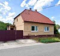 A family house in Rovensko with a slanted red roof and an iron gate.