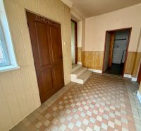 Interior of a family house with tiles and a sign on the door.