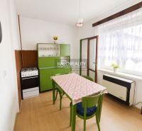 A kitchen in a family house with retro furniture and a wooden decor floor.
