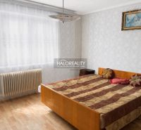 Bedroom in a family house with a wood-patterned floor and a radiator by the window.