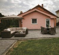 A family house in Martin nad Žitavou on Hlavná Street with a terrace and garden seating.